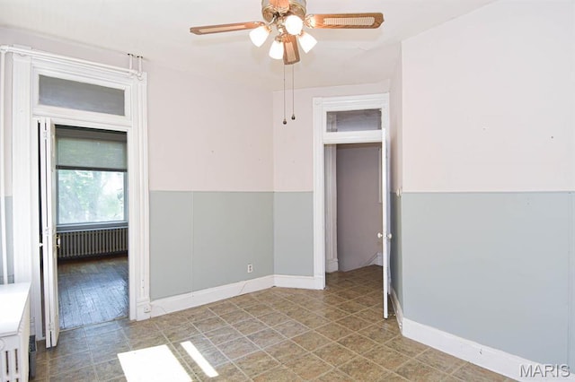 4207 Connecticut St, Saint Louis, MO 63116 - empty room with radiator, ceiling fan, and baseboards