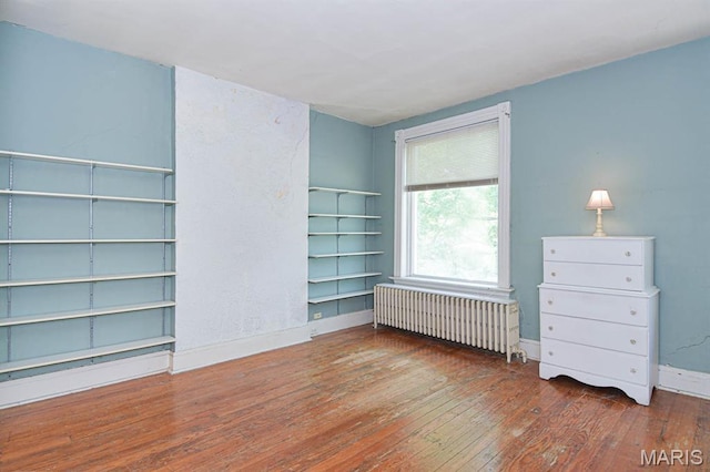 4207 Connecticut St, Saint Louis, MO 63116 - empty room with radiator heating unit, wood-type flooring, and baseboards