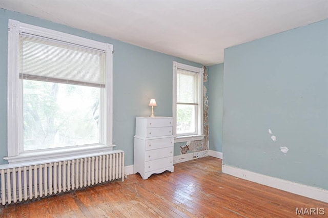 4207 Connecticut St, Saint Louis, MO 63116 - bedroom with radiator, wood-type flooring, and baseboards