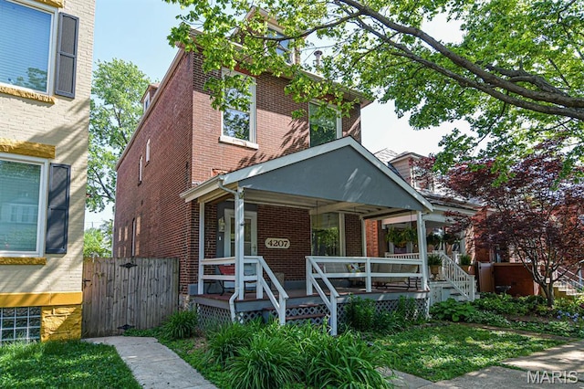 4207 Connecticut St, Saint Louis, MO 63116 - traditional style home featuring brick siding, covered porch, and fence