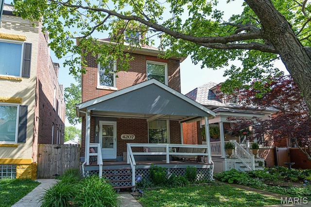 4207 Connecticut St, Saint Louis, MO 63116 - traditional style home with brick siding, covered porch, and fence
