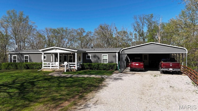 8325 Maple Ln, Dittmer, MO 63023 - manufactured / mobile home featuring a front yard, gravel driveway, and a detached carport