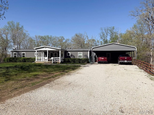 8325 Maple Ln, Dittmer, MO 63023 - manufactured / mobile home featuring driveway, a detached carport, and a front yard