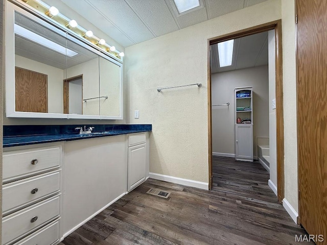 8325 Maple Ln, Dittmer, MO 63023 - bathroom featuring wood finished floors, a textured wall, vanity, and baseboards