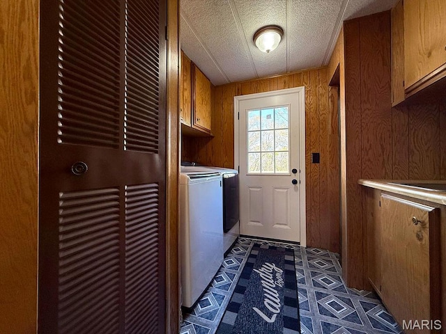 8325 Maple Ln, Dittmer, MO 63023 - laundry area featuring cabinet space, washer and clothes dryer, a heating unit, inlaid floor details, and wood walls