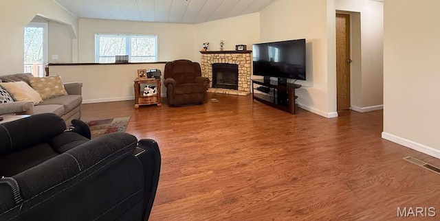 8325 Maple Ln, Dittmer, MO 63023 - living area with baseboards, wood finished floors, and a fireplace