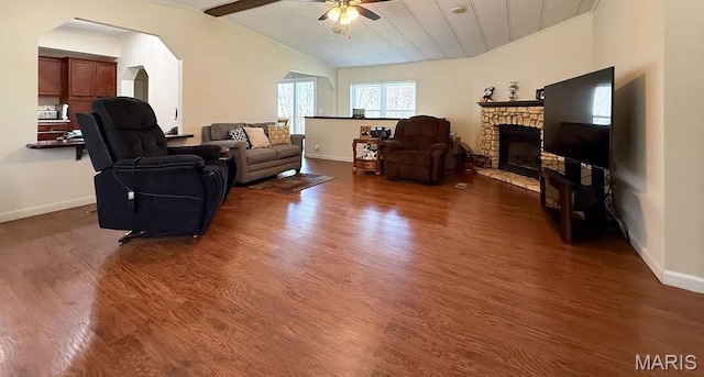 8325 Maple Ln, Dittmer, MO 63023 - living area featuring a ceiling fan, vaulted ceiling, dark wood-type flooring, baseboards, and a fireplace