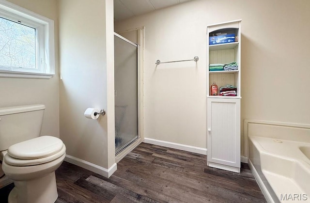 8325 Maple Ln, Dittmer, MO 63023 - bathroom with wood finished floors, toilet, a stall shower, a garden tub, and baseboards