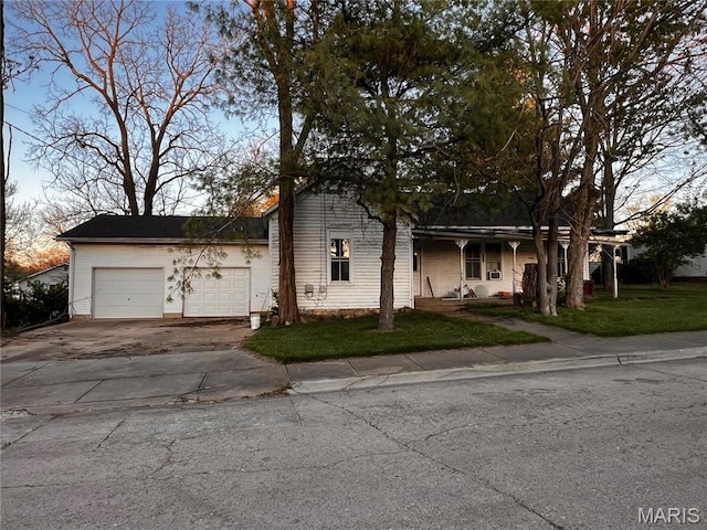 410 N Jackson St, Farmington, MO 63640 - view of front facade with driveway, an attached garage, a front yard, and a porch