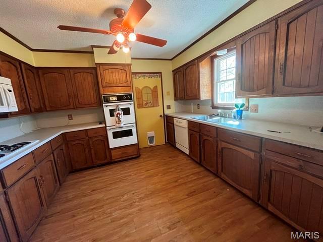 11799 County Road 637, Dexter, MO 63841 - kitchen with white appliances, a textured ceiling, ceiling fan, light wood-style floors, and light countertops