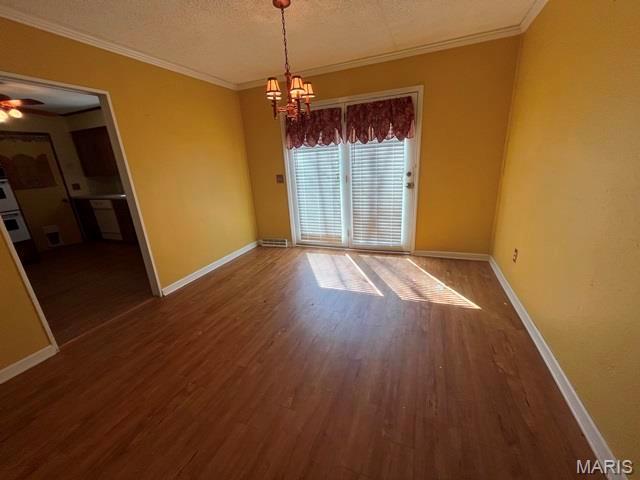 11799 County Road 637, Dexter, MO 63841 - empty room with a chandelier, wood finished floors, baseboards, crown molding, and a ceiling fan