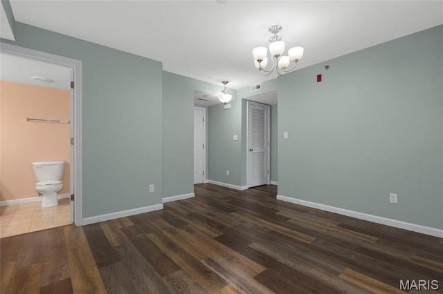 9744 Bexley Station Dr Unit F, Saint Louis, MO 63123 - empty room featuring a chandelier and wood finished floors