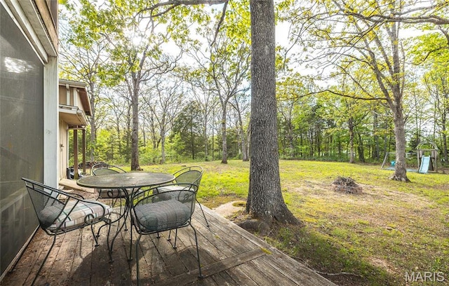 1109 Pawnee Dr, Cuba, MO 65453 - wooden deck featuring outdoor dining area, an outdoor fire pit, and a lawn