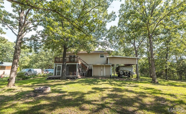 1109 Pawnee Dr, Cuba, MO 65453 - rear view of house with stairway, a fire pit, a wooden deck, and a yard