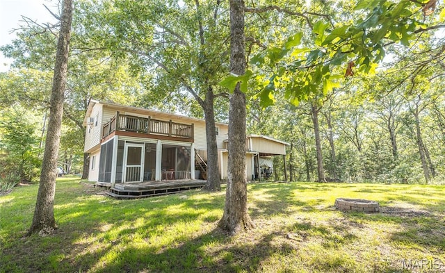 1109 Pawnee Dr, Cuba, MO 65453 - rear view of property featuring a yard, a wooden deck, and a fire pit
