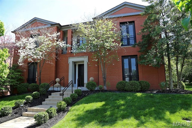 7788 Pershing Ave, Clayton, MO 63105 - view of front of property with a front yard, brick siding, and a balcony