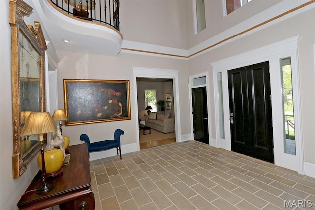 7788 Pershing Ave, Clayton, MO 63105 - foyer featuring baseboards, a towering ceiling, and tile patterned flooring