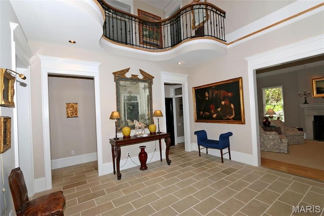 7788 Pershing Ave, Clayton, MO 63105 - tiled foyer entrance featuring a fireplace and baseboards