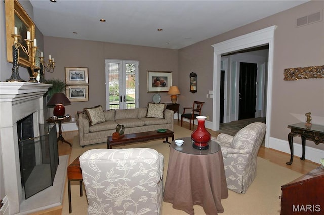 7788 Pershing Ave, Clayton, MO 63105 - living area featuring a fireplace with raised hearth, wood finished floors, french doors, and baseboards