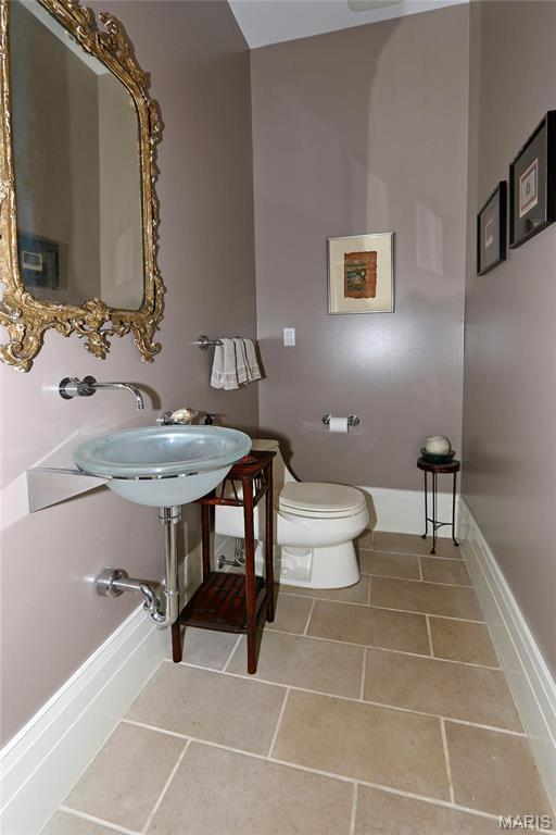 7788 Pershing Ave, Clayton, MO 63105 - bathroom with toilet, tile patterned floors, and baseboards