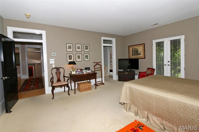 7788 Pershing Ave, Clayton, MO 63105 - bedroom with french doors, light carpet, and access to exterior