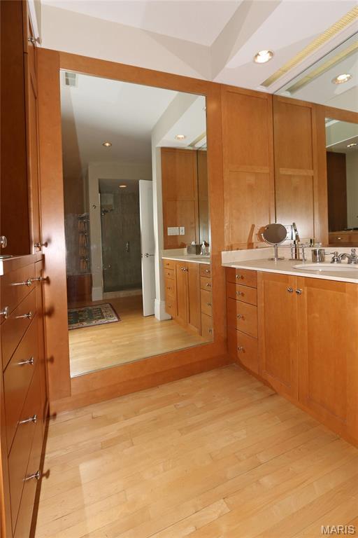 7788 Pershing Ave, Clayton, MO 63105 - full bath with a shower stall, wood finished floors, recessed lighting, and vanity