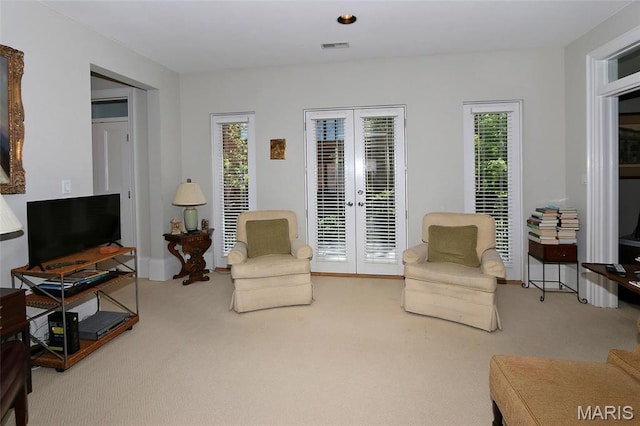 7788 Pershing Ave, Clayton, MO 63105 - living area featuring carpet, french doors, and plenty of natural light
