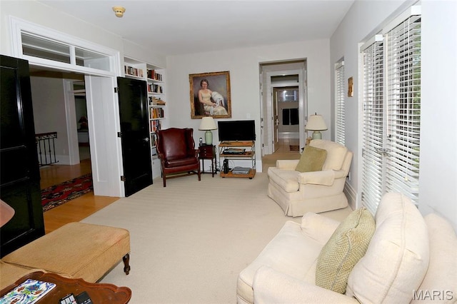 7788 Pershing Ave, Clayton, MO 63105 - living area with built in shelves and carpet floors