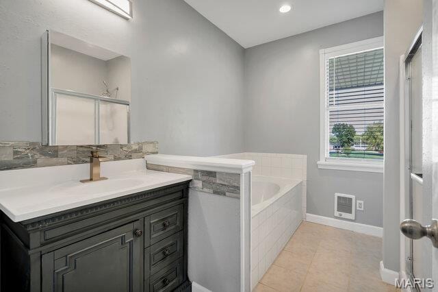 433 Snipes Dr, Saint Charles, MO 63303 - full bath featuring a bath, vanity, heating unit, tile patterned floors, and a shower