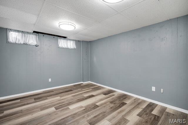 433 Snipes Dr, Saint Charles, MO 63303 - below grade area with a drop ceiling and wood finished floors