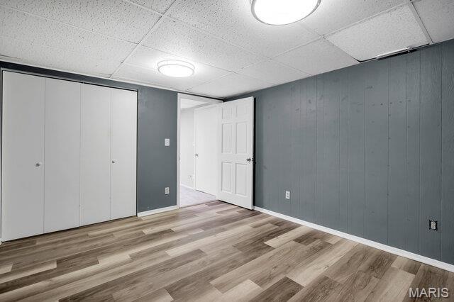 433 Snipes Dr, Saint Charles, MO 63303 - unfurnished bedroom featuring a drop ceiling, wood finished floors, and a closet