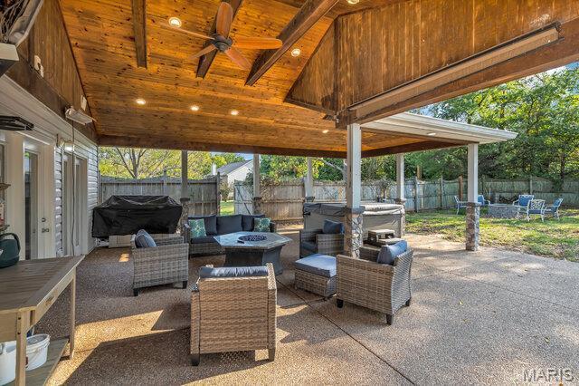 433 Snipes Dr, Saint Charles, MO 63303 - fenced backyard featuring an outdoor living space with a fire pit, a patio, and ceiling fan
