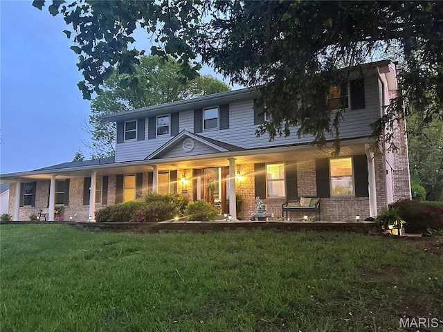 433 Snipes Dr, Saint Charles, MO 63303 - traditional-style home featuring brick siding, a front lawn, and a porch