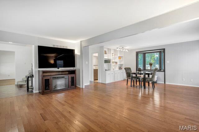 433 Snipes Dr, Saint Charles, MO 63303 - living room with wood finished floors, a chandelier, and a fireplace
