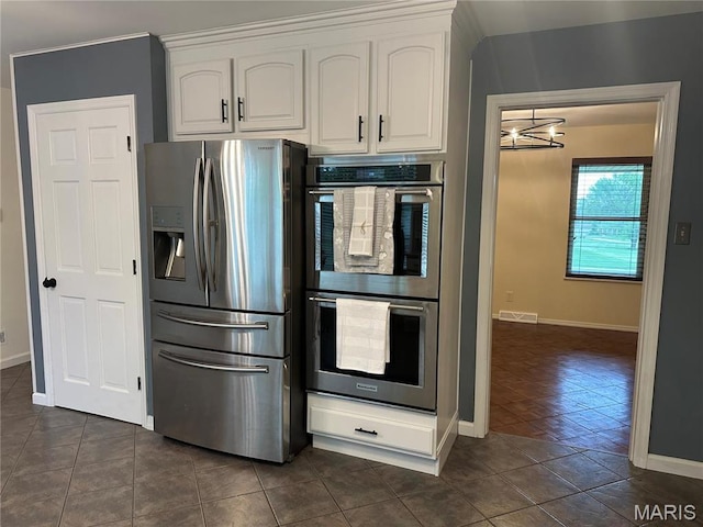 433 Snipes Dr, Saint Charles, MO 63303 - kitchen featuring stainless steel appliances, white cabinetry, and dark tile patterned floors