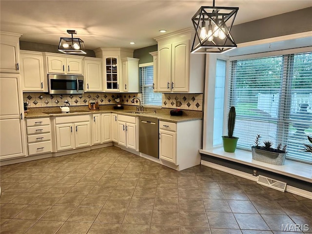 433 Snipes Dr, Saint Charles, MO 63303 - kitchen featuring stainless steel appliances, backsplash, glass insert cabinets, hanging light fixtures, and recessed lighting