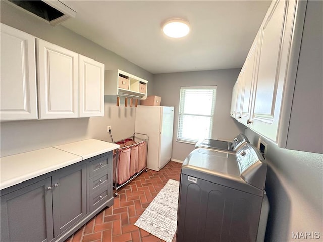 433 Snipes Dr, Saint Charles, MO 63303 - laundry room featuring cabinet space, separate washer and dryer, and brick flooring