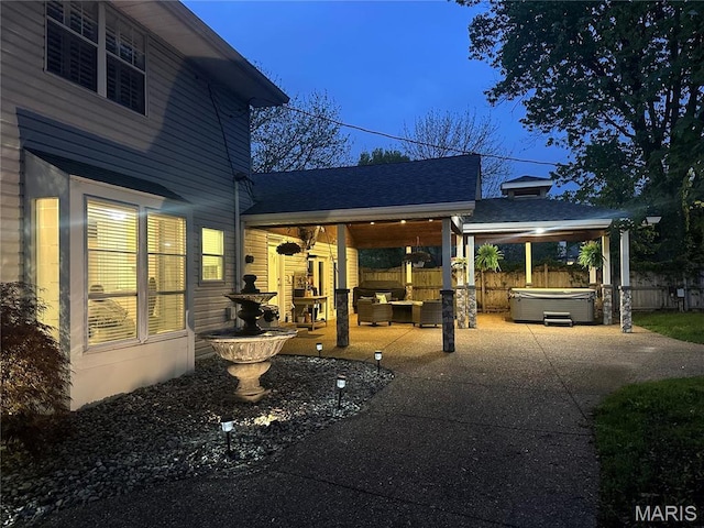 433 Snipes Dr, Saint Charles, MO 63303 - view of patio with a hot tub, driveway, and an outdoor hangout area