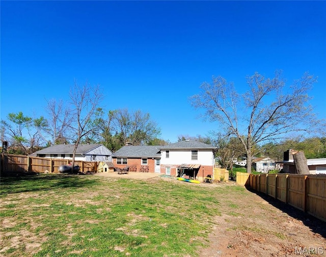 rear view of house with a patio area and brick siding