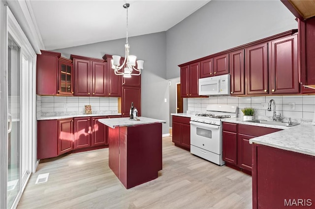 1958 Cathedral Hill Dr, Saint Louis, MO 63138 - kitchen featuring white appliances, a sink, dark brown cabinets, lofted ceiling, and a chandelier