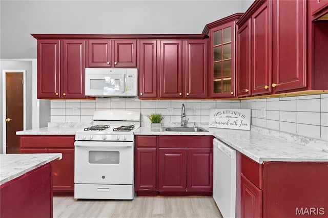 1958 Cathedral Hill Dr, Saint Louis, MO 63138 - kitchen featuring white appliances, a sink, dark brown cabinets, and tasteful backsplash