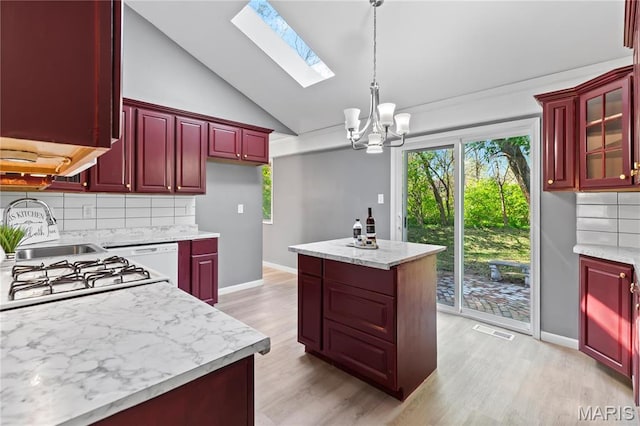 1958 Cathedral Hill Dr, Saint Louis, MO 63138 - kitchen with dark brown cabinets, a chandelier, backsplash, a sink, and light wood-style flooring
