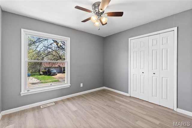 1958 Cathedral Hill Dr, Saint Louis, MO 63138 - unfurnished bedroom featuring wood finished floors, a closet, baseboards, and ceiling fan