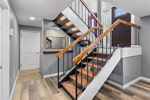 1958 Cathedral Hill Dr, Saint Louis, MO 63138 - stairway with baseboards, wood finished floors, and recessed lighting