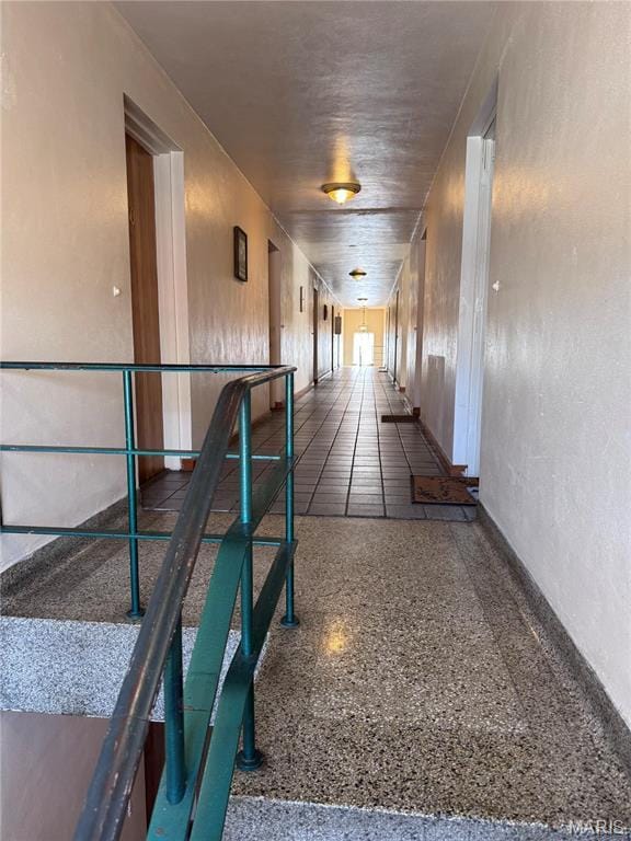 hallway featuring speckled floor