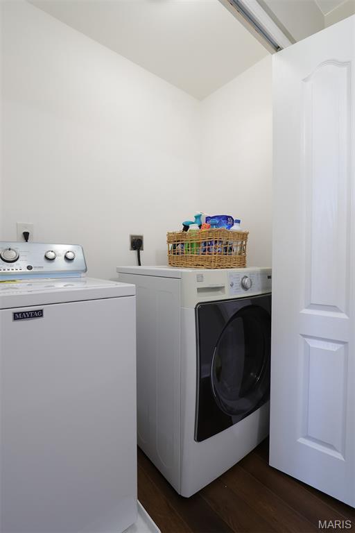 2122 Birchwood Dr, Barnhart, MO 63012 - clothes washing area featuring washing machine and clothes dryer and dark wood-style floors