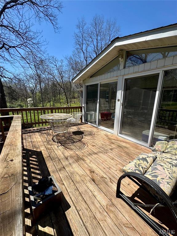 wooden deck featuring outdoor dining area