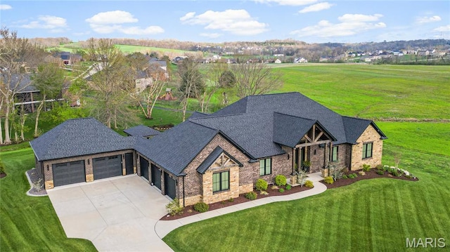 view of front of home with brick siding, an attached garage, driveway, a front yard, and roof with shingles