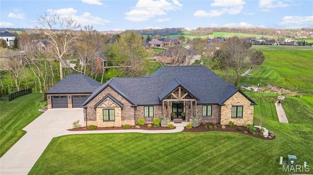view of front facade featuring a front yard, a garage, brick siding, and concrete driveway