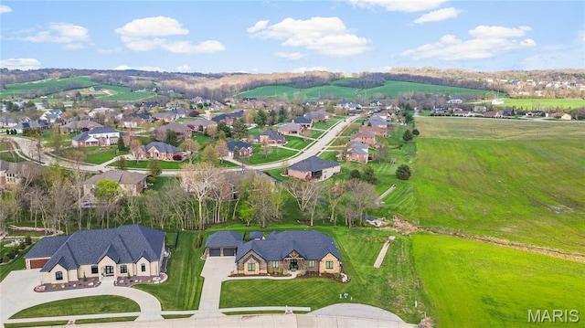 aerial view of property and surrounding area with nearby suburban area